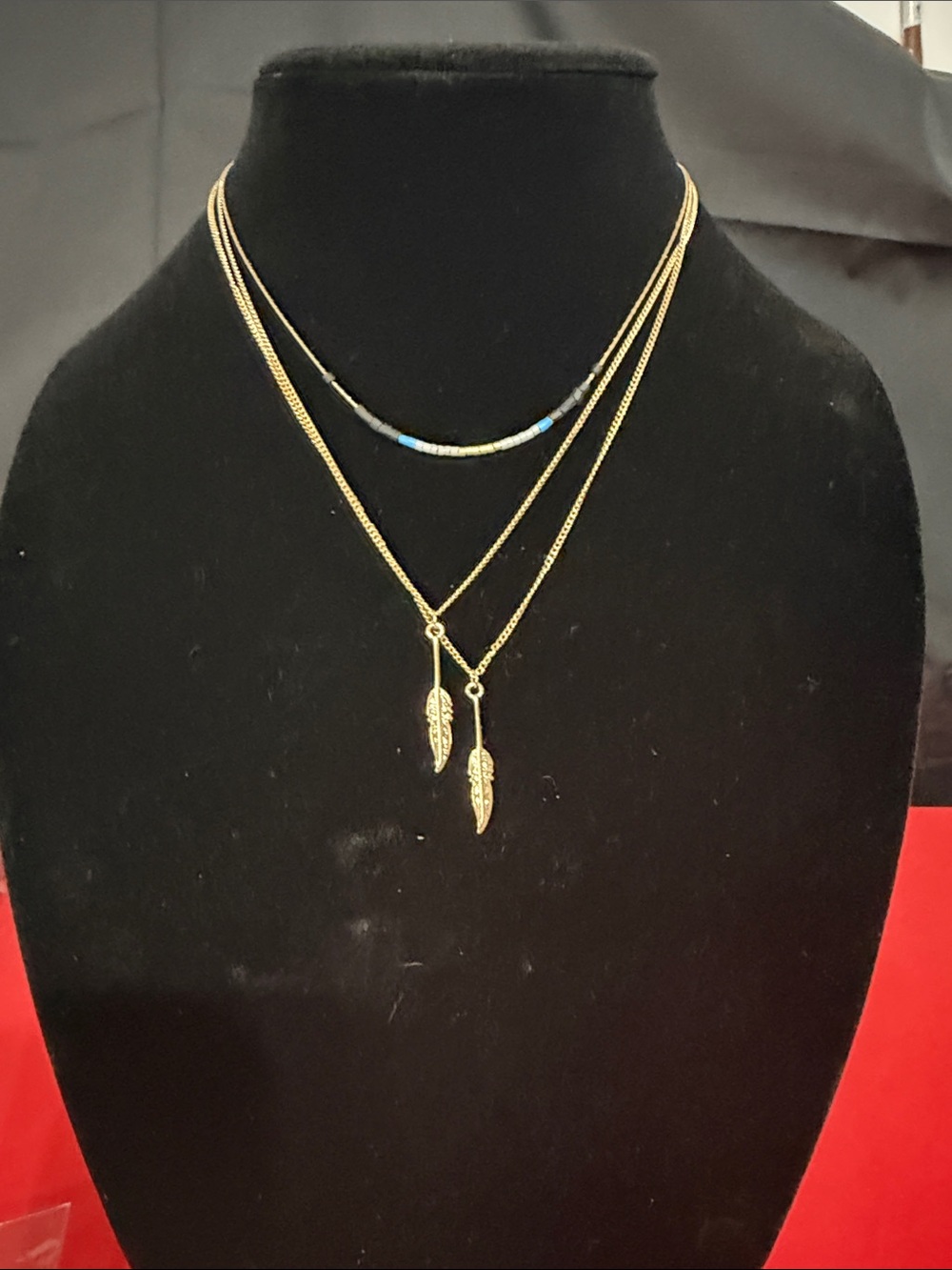 Gold Layered Feather Necklace with Blue Bead Accent